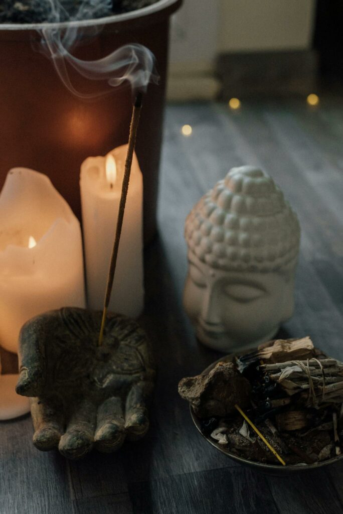 Burning Candles and Incense on a Wooden Surface