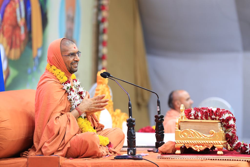 Monk Talking to a Crowd From a Stage